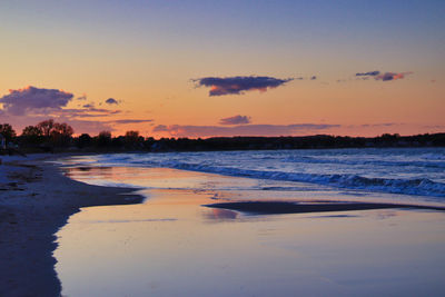 Scenic view of beach against sky during sunset