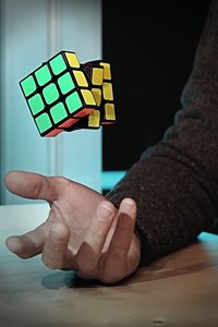 Cropped hand catching puzzle cube 