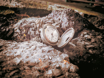 High angle view of old clock on rock