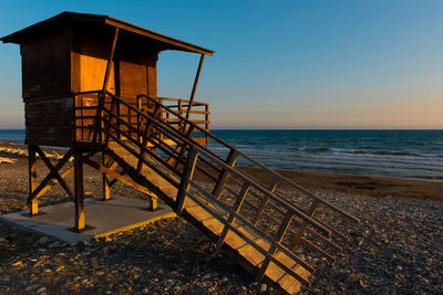 Lifeguard hut on beach against clear sky