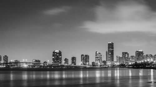 Illuminated cityscape against sky at night