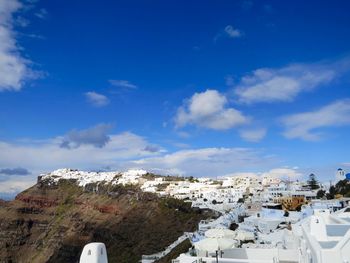 Scenic view of snowcapped mountains against blue sky