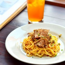 Close-up of noodles and drink on table