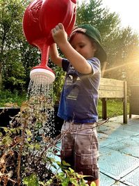 Rear view of woman holding umbrella