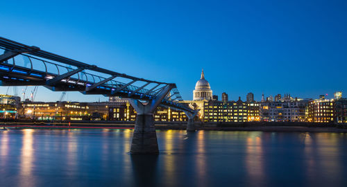 View of bridge over river at night