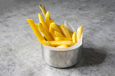 High angle view of yellow fries on white background