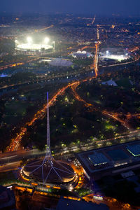 High angle view of illuminated buildings in city at night