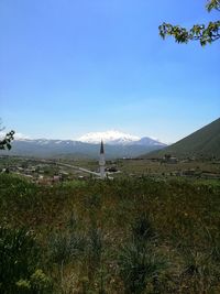 Scenic view of landscape against blue sky