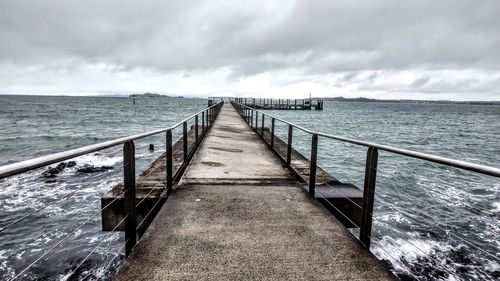 Pier over sea against sky