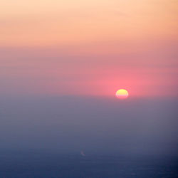 Scenic view of sea against romantic sky at sunset