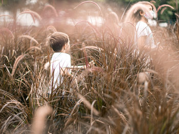 Rear view of boy standing on field