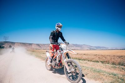 Man riding bicycle on field