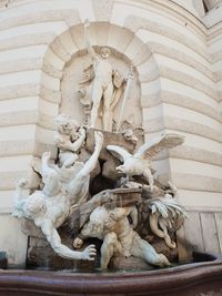 Low angle view of statue against building