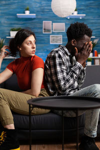 Side view of woman using laptop at home