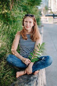 Portrait of young woman sitting outdoors