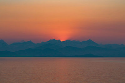 Scenic view of mountains against orange sky