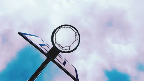 Low angle view of basketball hoop against cloudy sky