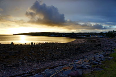 Scenic view of beach against sky during sunset