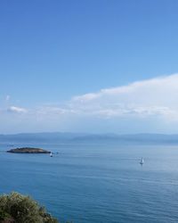 Scenic view of sea against blue sky