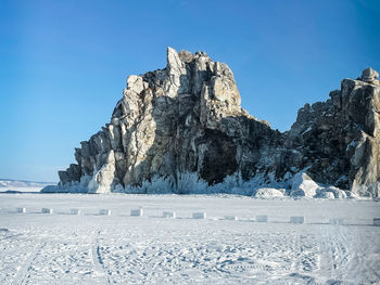 Scenic view of snowcapped mountains against clear blue sky