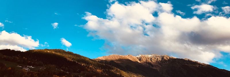 Low angle view of mountain against blue sky