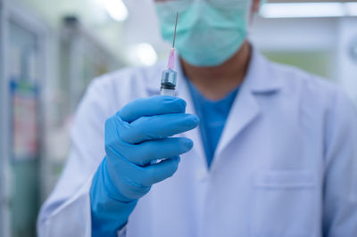 Midsection of person holding umbrella