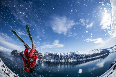 Man performing flip on skis in svalbard