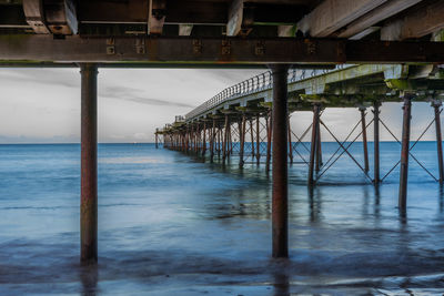 Pier over sea against sky