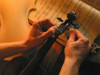 Cropped image of hand repairing violin