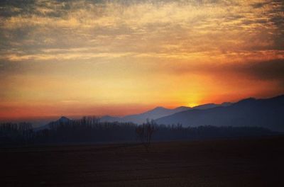 Scenic view of mountains against sky at sunset