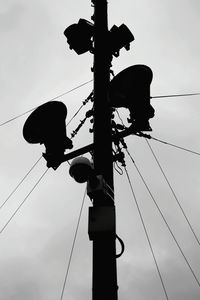 Low angle view of electricity pylon against sky