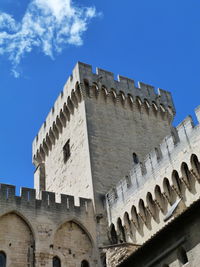 Low angle view of historic building against blue sky