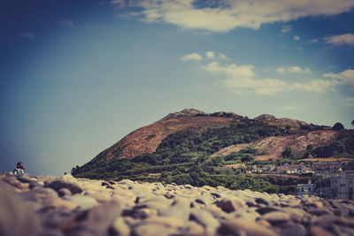 Surface level of rocks on land against sky