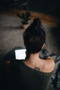 Rear view of woman sitting outdoors