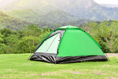 Green color camping tent in mountain range landscapes