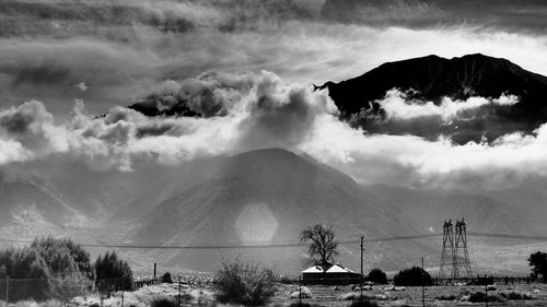 Scenic view of mountains against cloudy sky