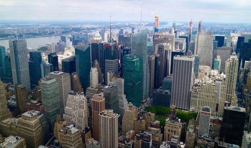 Aerial view of modern buildings in city against sky