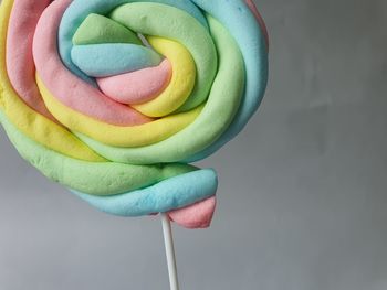 Close-up of multi colored lollipops on white ground 