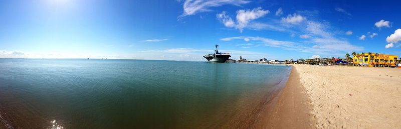 Panoramic view of sea against blue sky