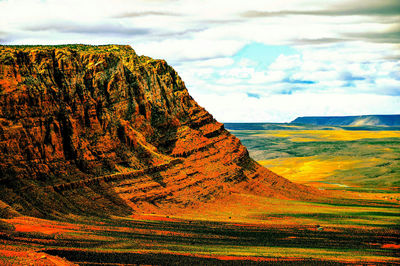 Scenic view of mountains against cloudy sky