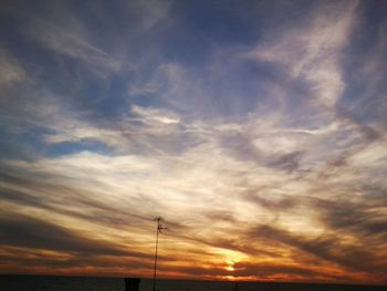 Low angle view of cloudy sky at sunset