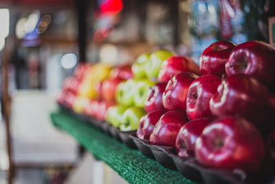 Stack of apples arranged for sale at market stall