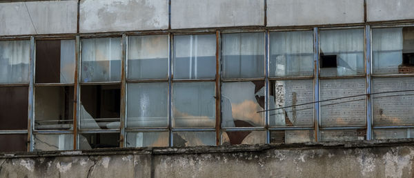 Abandoned factory warehouse with broken windows