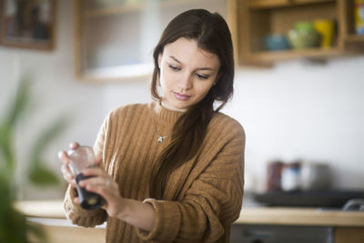 Young woman cooking in the kitchen