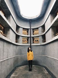 Full length of woman standing on floor of building