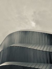 Low angle view of building against cloudy sky