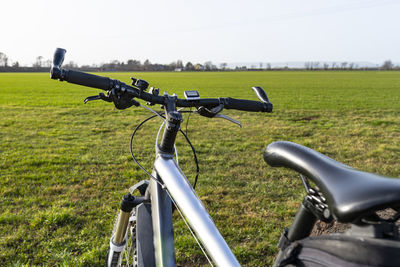 A bicycle handlebar seen from the first person perspective. bicycle frame and bicycle accessories