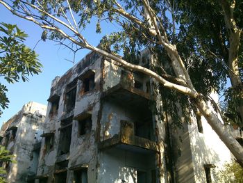 Low angle view of abandoned building against sky