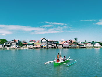 People on boat against sky