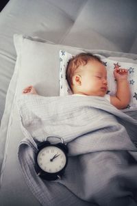 High angle view of baby boy sleeping on bed